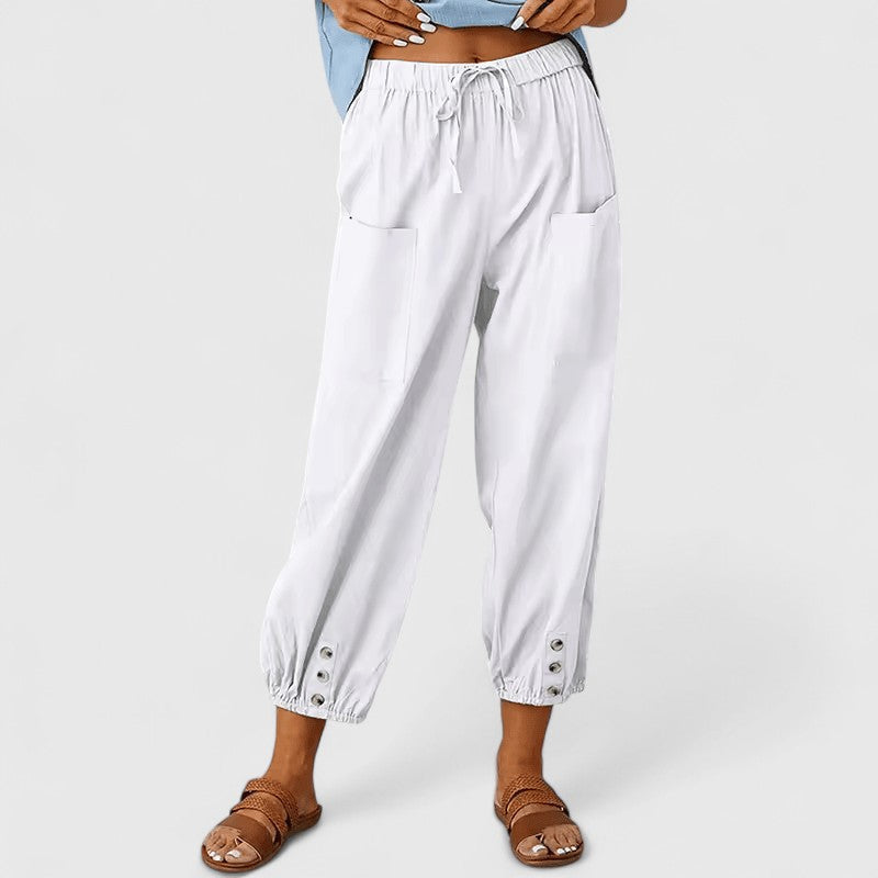 Cropped broek dames met taps toelopende pijpen en knoopdetail bij de enkel