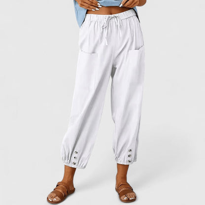 Cropped broek dames met taps toelopende pijpen en knoopdetail bij de enkel