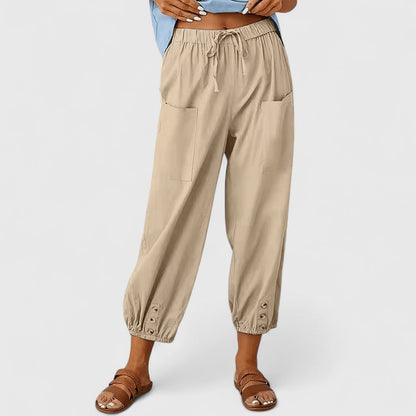 Cropped broek dames met taps toelopende pijpen en knoopdetail bij de enkel